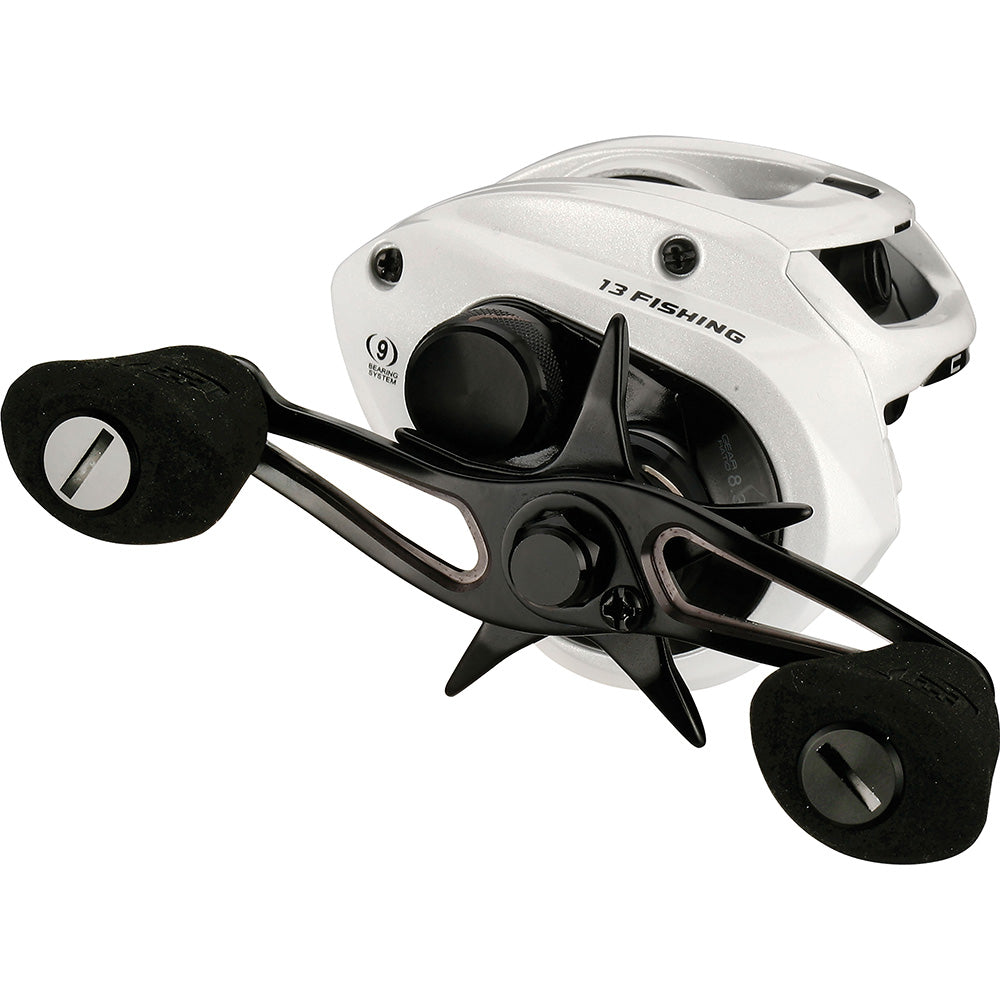 Fishing reel with white frame and black components on a white background