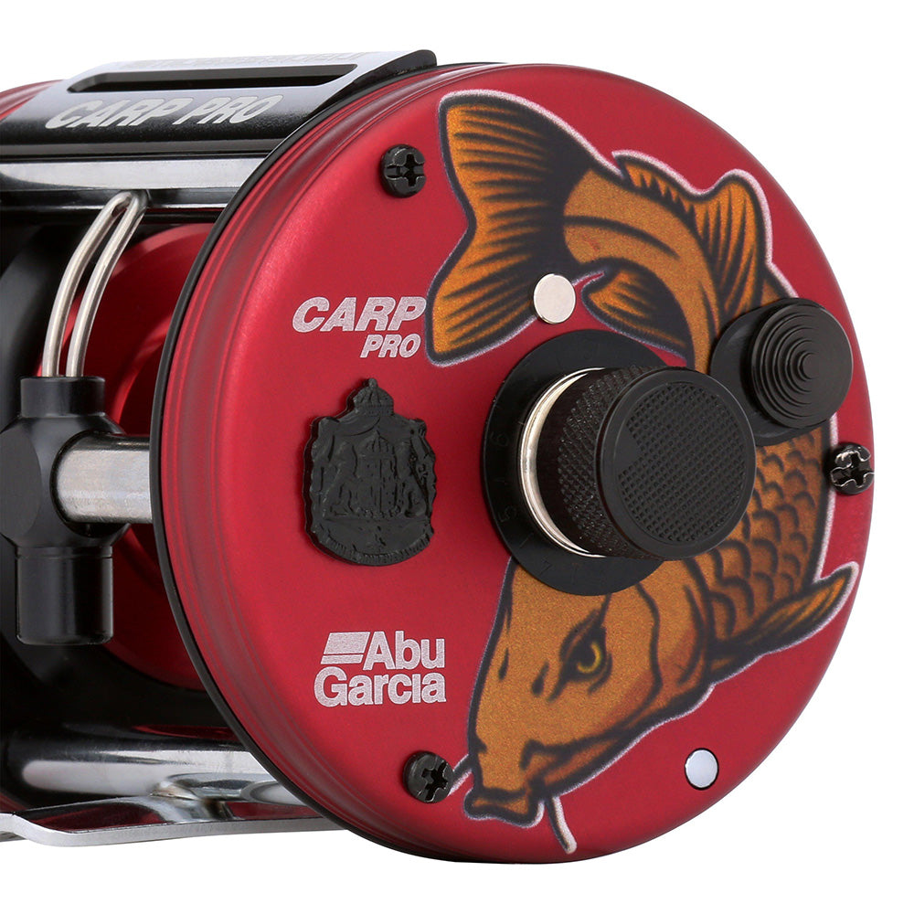 Red Abu Garcia Carp Pro fishing reel with fish design on a white background