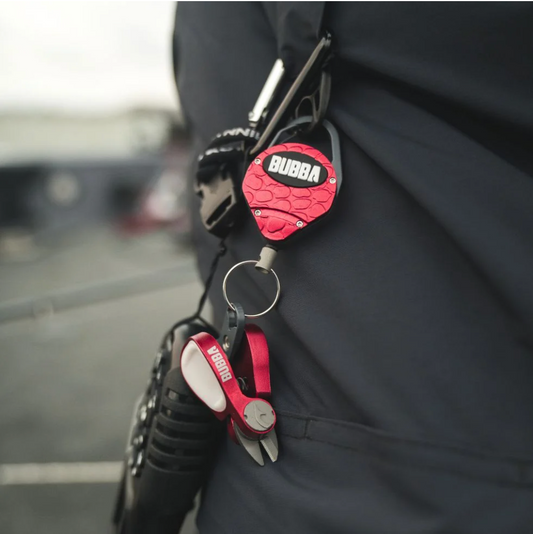 Red Bubba brand tool attached to a keychain on a person's pocket.