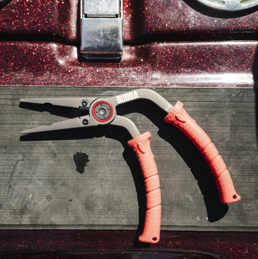 Close-up of motorcycle handlebar with pink grips on a textured surface