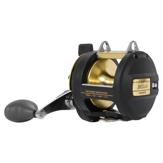 Fishing reel with black and gold finish on a white background