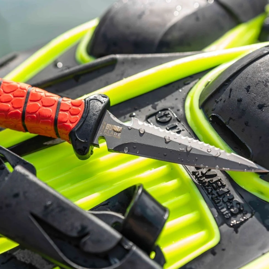 Fishing knife with red handle on a green and black fishing rod