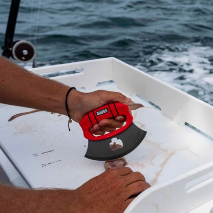 Person using a red and black Bubba brand tool on a boat with water in the background