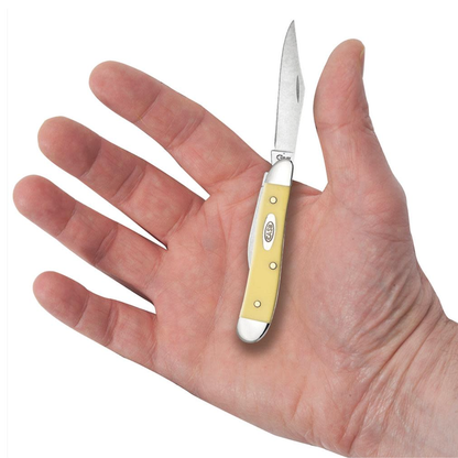 Small pocket knife with yellow handle held in a hand on a white background