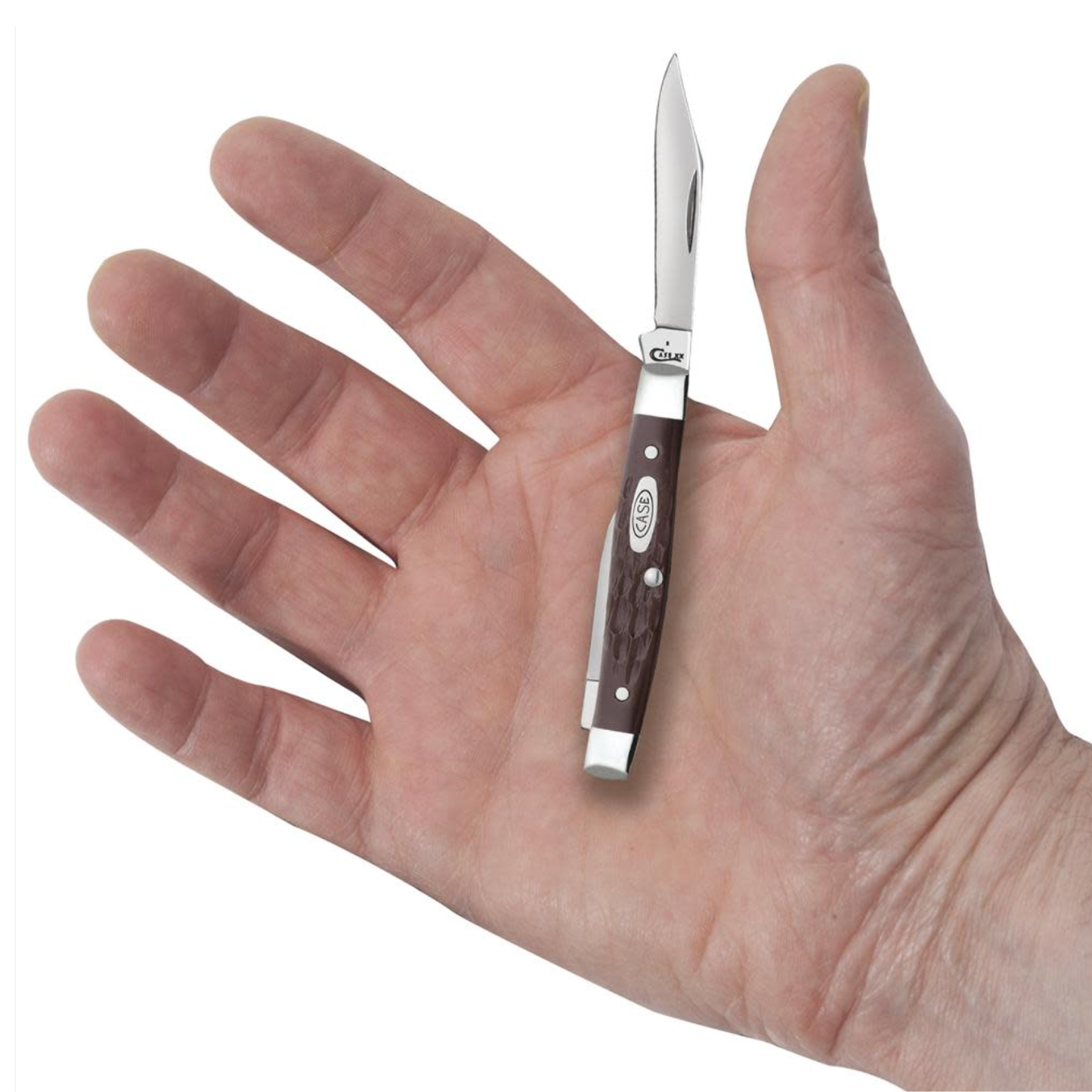 Small pocket knife held in a hand against a white background