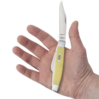 Hand holding a yellow pocket knife with a white background
