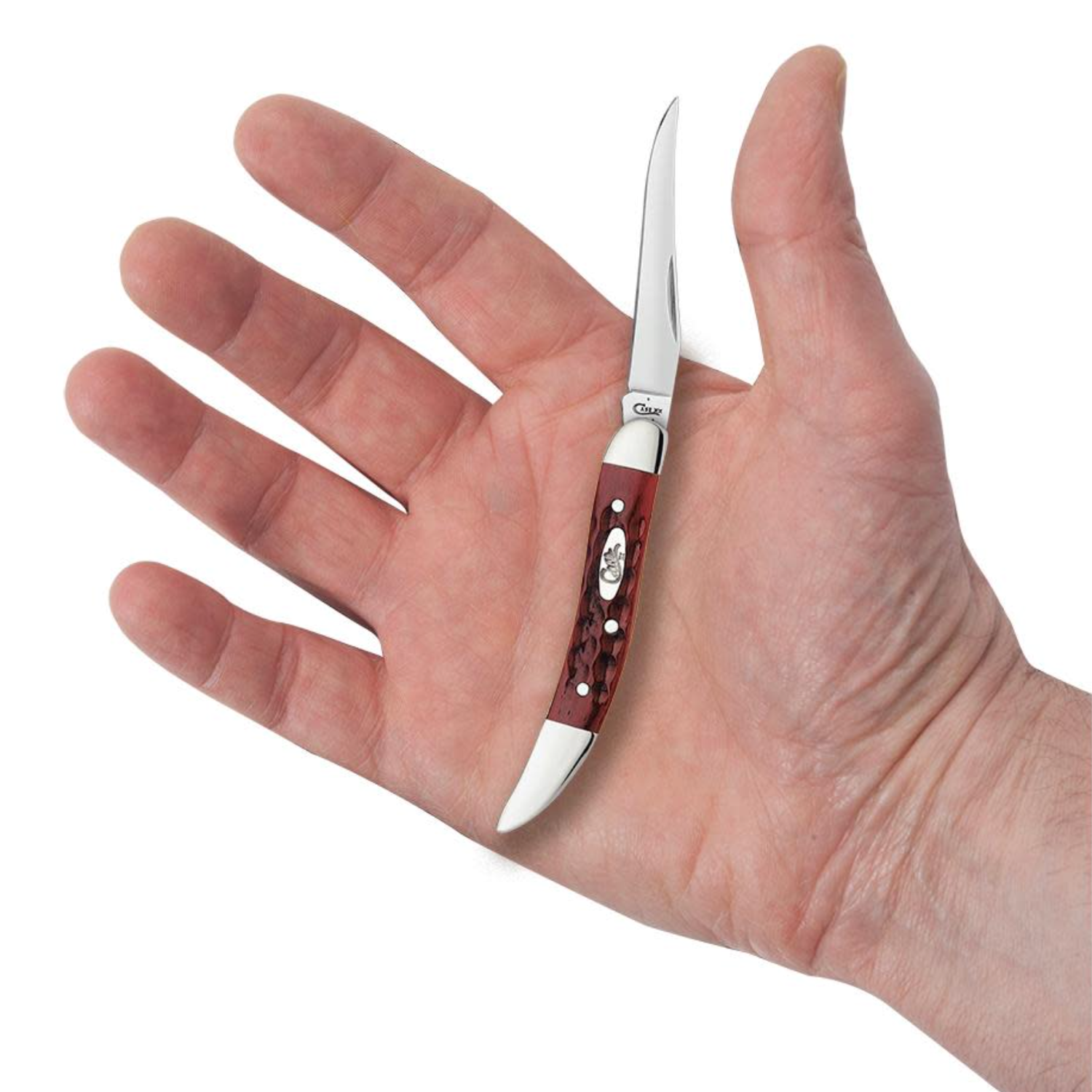 Small knife with a red handle held in a hand against a white background