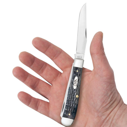 Knife with a decorative handle held in a hand against a white background