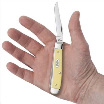 Small yellow pocket knife held in a hand against a white background