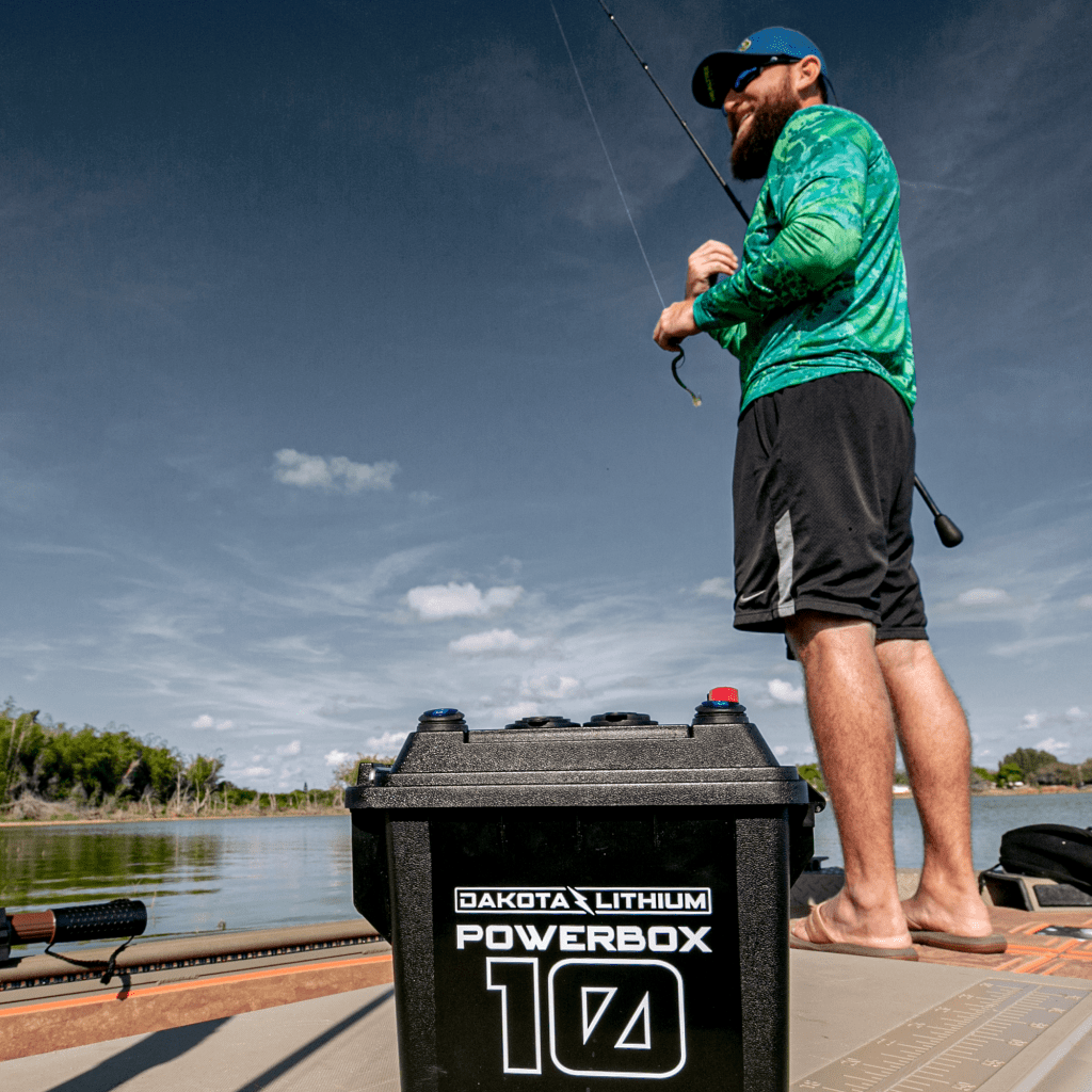 Man fishing on a dock with a Dakota Lithium PowerBox 104 in the foreground