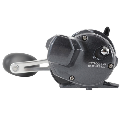 Black fishing reel with 'Tekota' branding on a white background