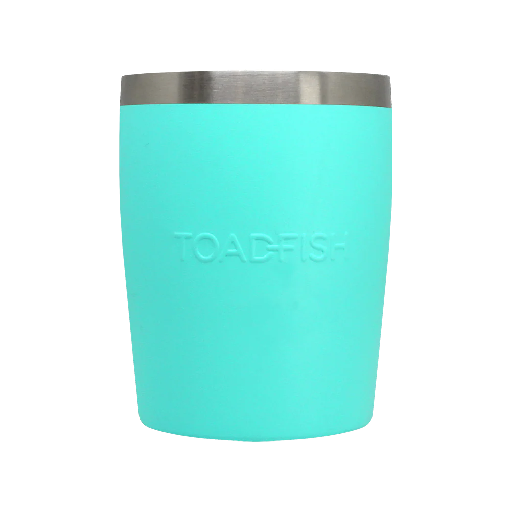 Turquoise tumbler with silver rim on a white background