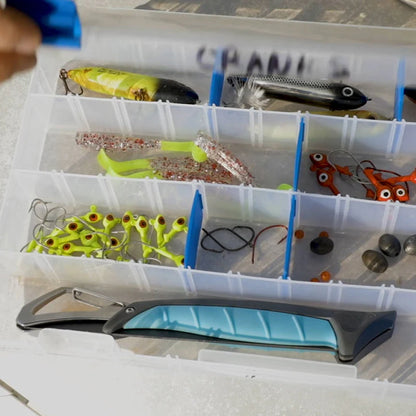 Fishing tackle box with various fishing lures and tools.