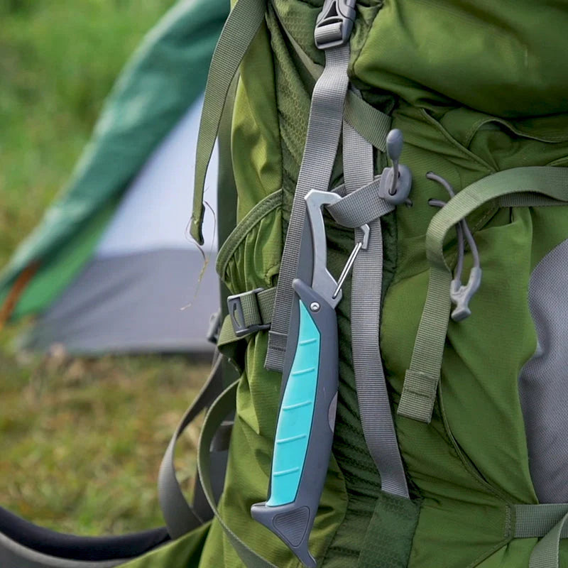 Green backpack with a carabiner and tent in the background