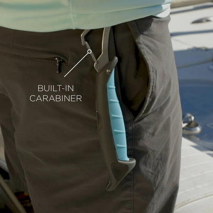Person wearing dark pants with a built-in carabiner attached, on a dock.