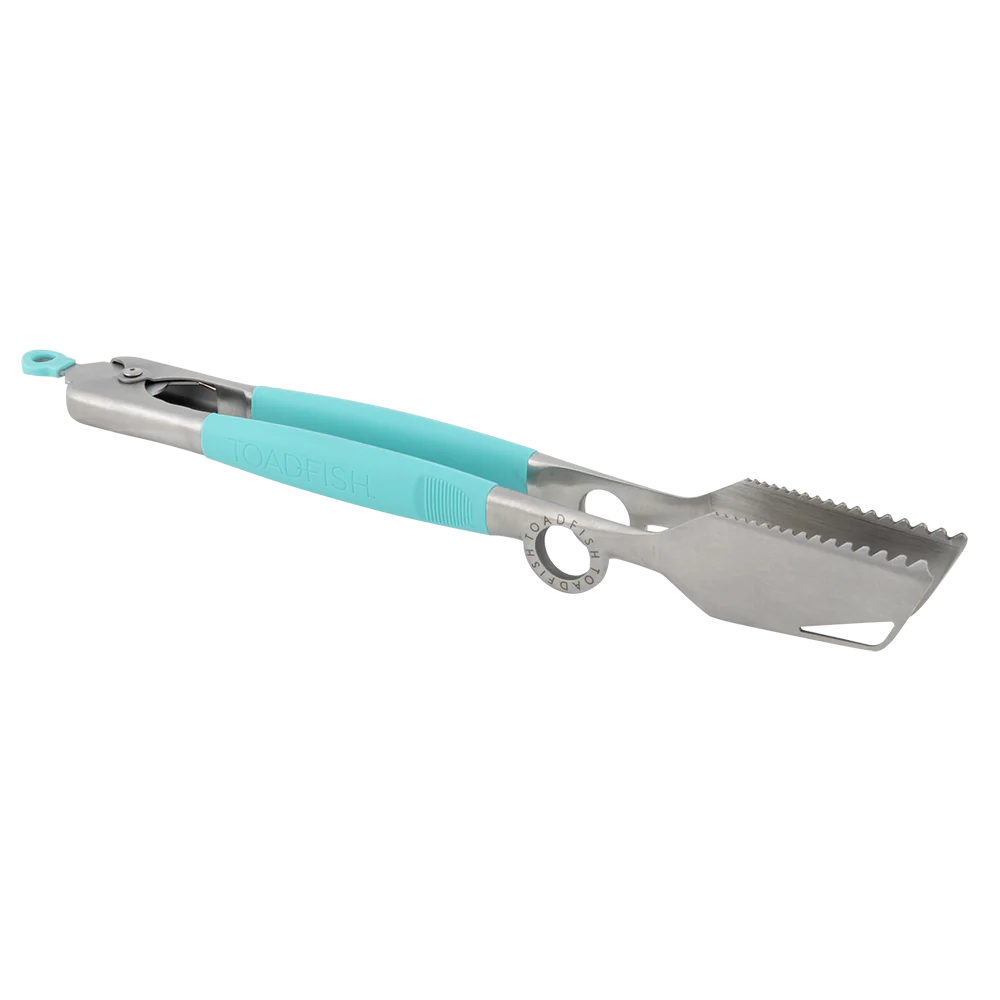 Metallic grill tool with turquoise handle on a white background