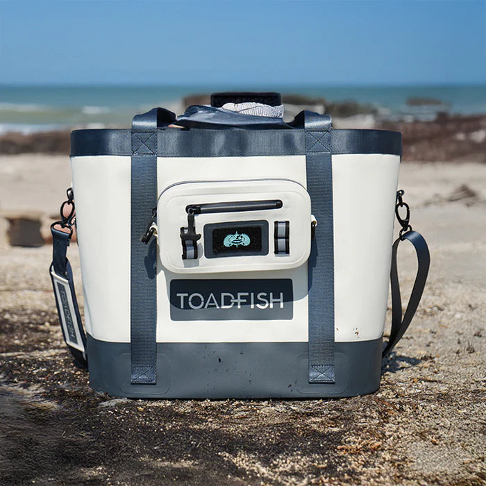Cooler bag with 'Toadfish' branding on a beach