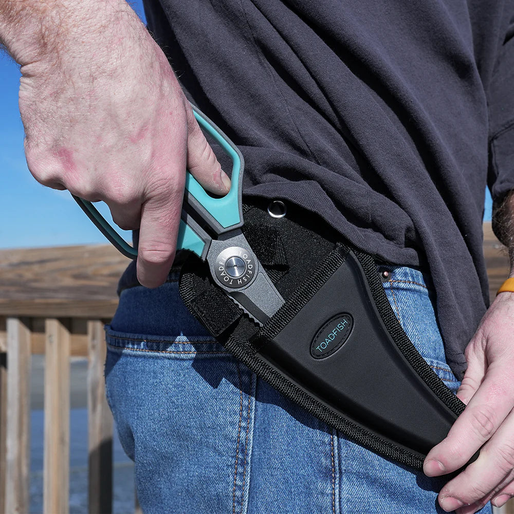 Person wearing a black belt with a tool holder, outdoors.