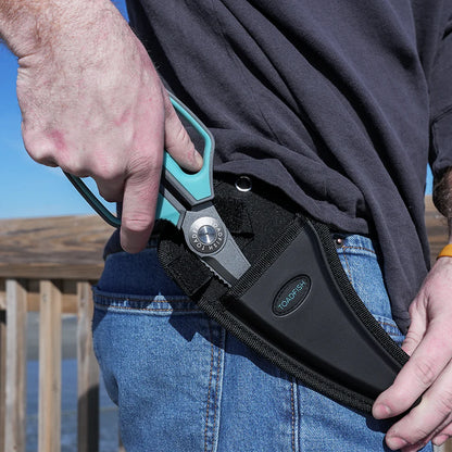 Person wearing a black belt with a tool holder, outdoors.