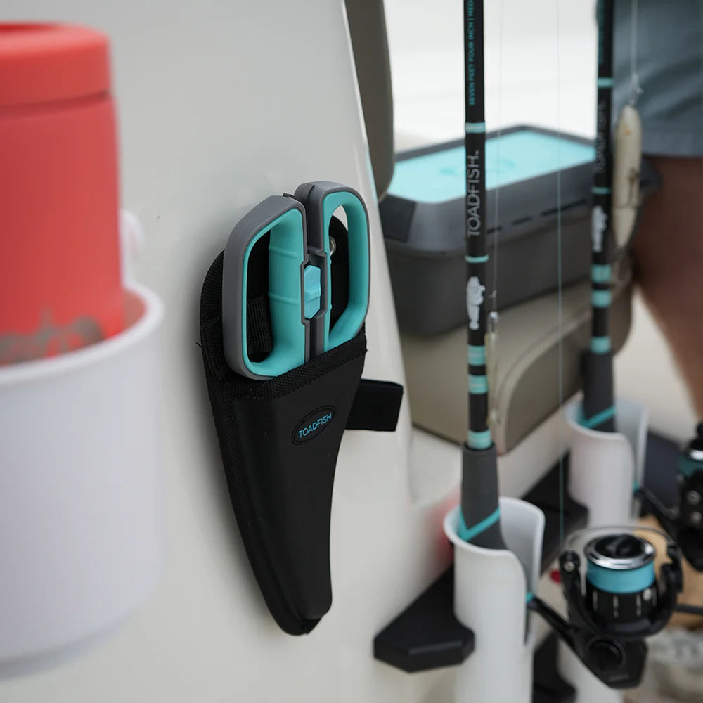Wall-mounted fishing rod holder with fishing rods and tackle box in the background