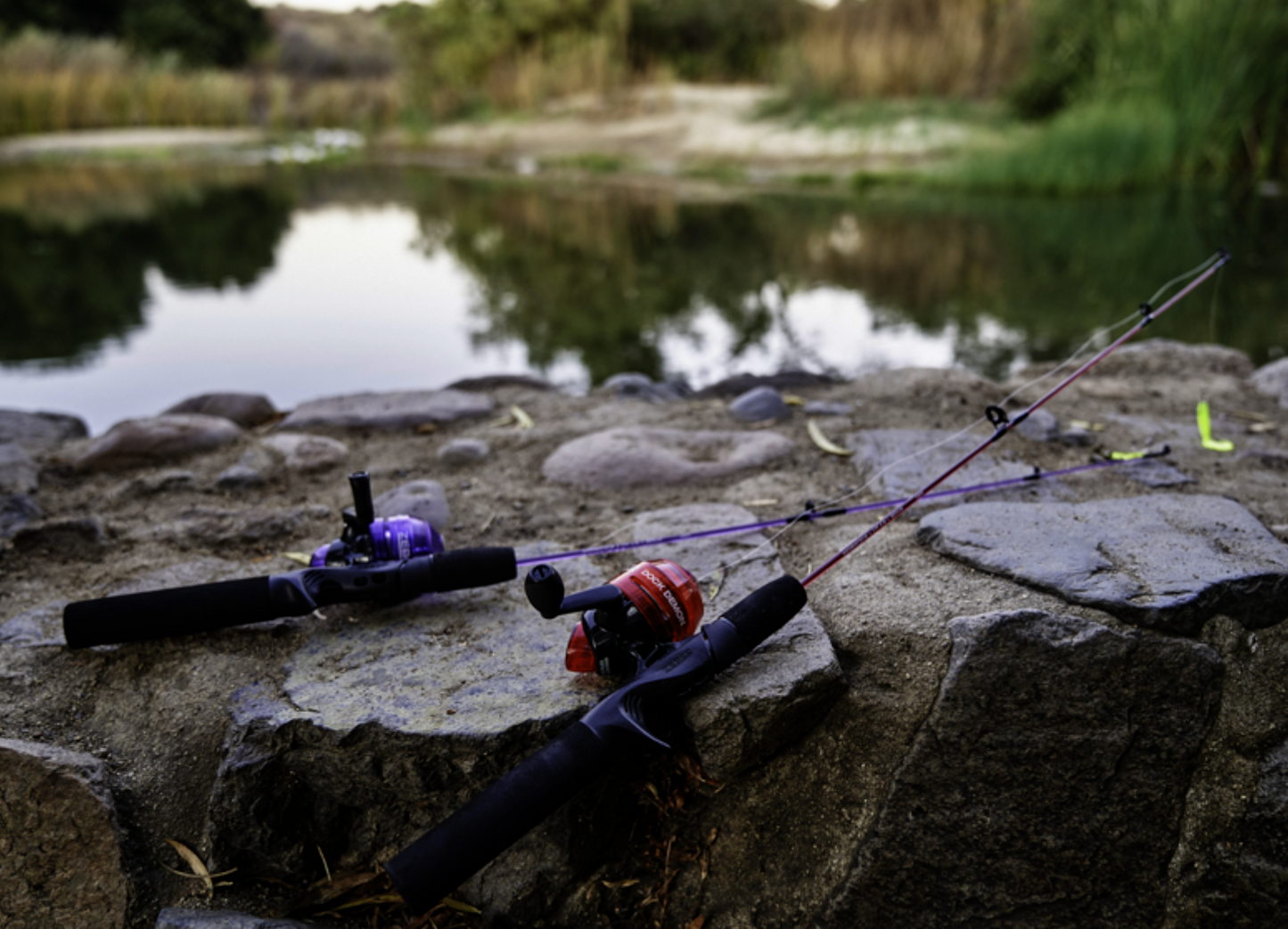 Fishing rod and reel set with purple accents on a white background