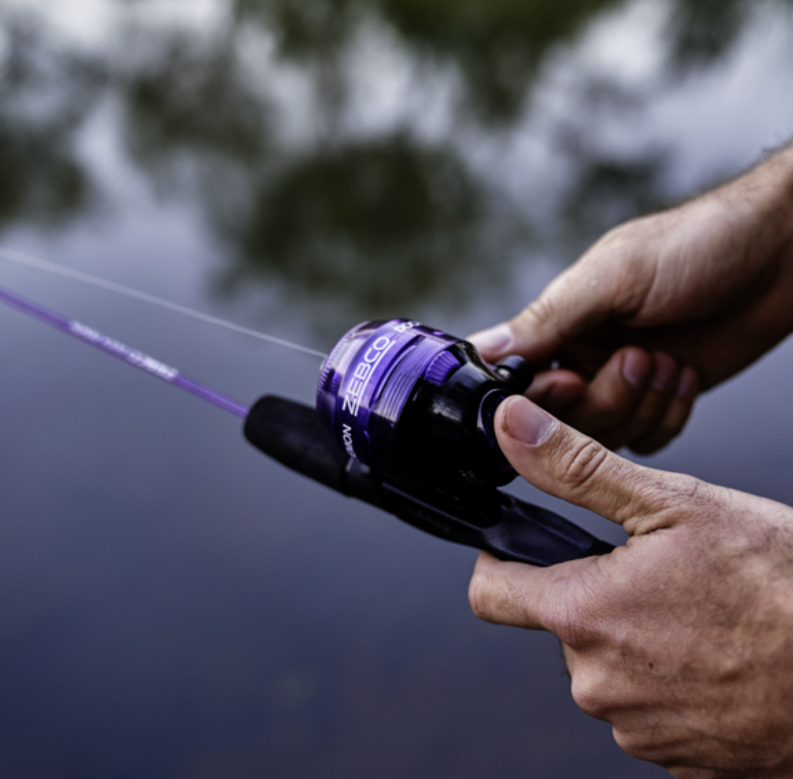 Fishing rod and reel set with purple accents on a white background
