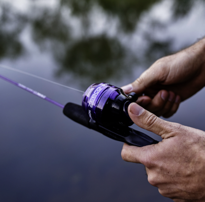 Fishing rod and reel set with purple accents on a white background